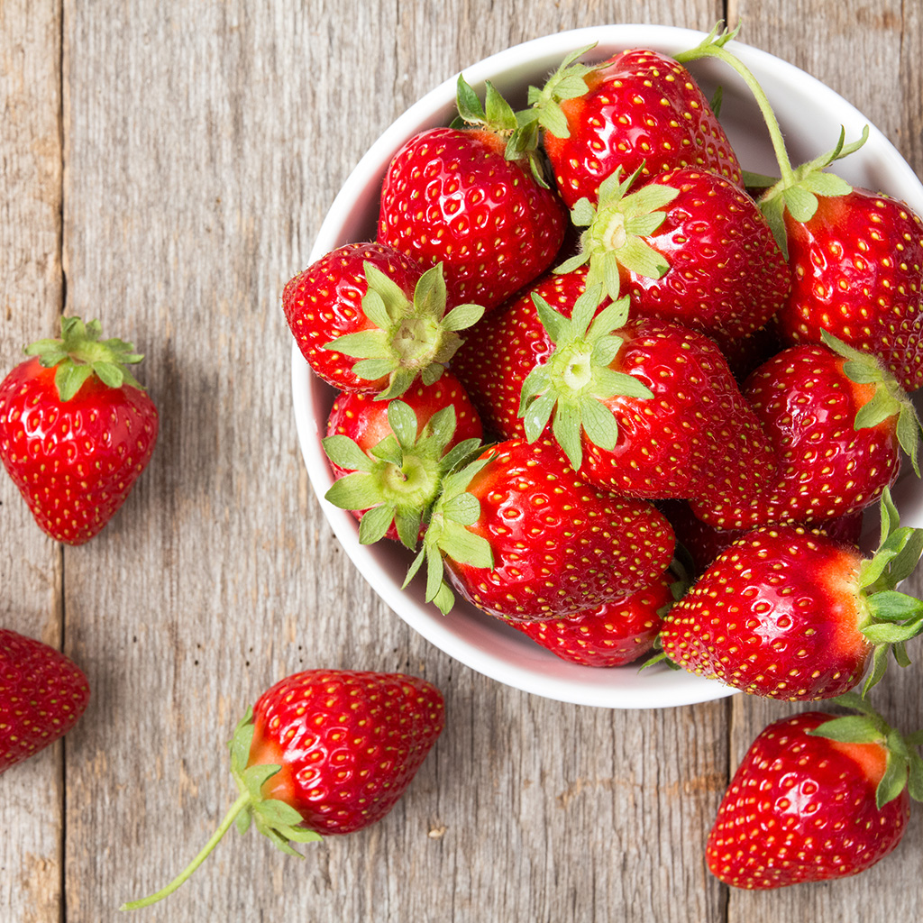 red, ripe strawberries in a bowl